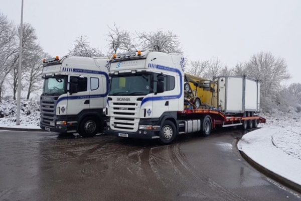 Skytrux lorries in snowy scene
